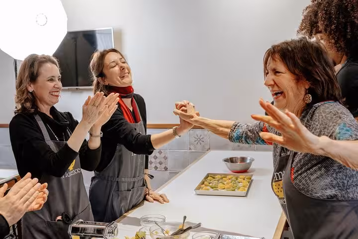 Participants joyfully celebrating their cooking success at MaMa Florence gluten-free Italian class.