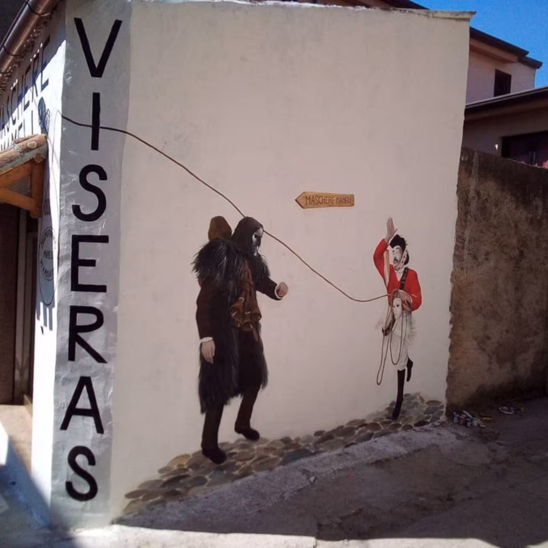 Colorful mural in Mamoiada depicting traditional Sardinian figures, highlighting cultural heritage and mask traditions.