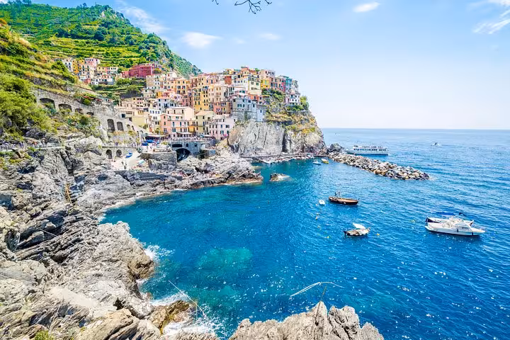 Picturesque Manarola perched on cliffs with azure sea views, a highlight of Cinque Terre hiking tours from La Spezia.