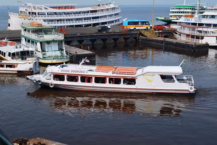 Passenger boat at Manaus port for Amazon Negro River half-day expedition tour with scenic river cruise views