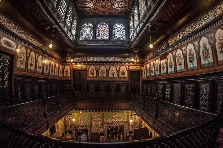 Ornate hall inside Manial Palace in Cairo with stained-glass windows and Islamic woodwork on day tour