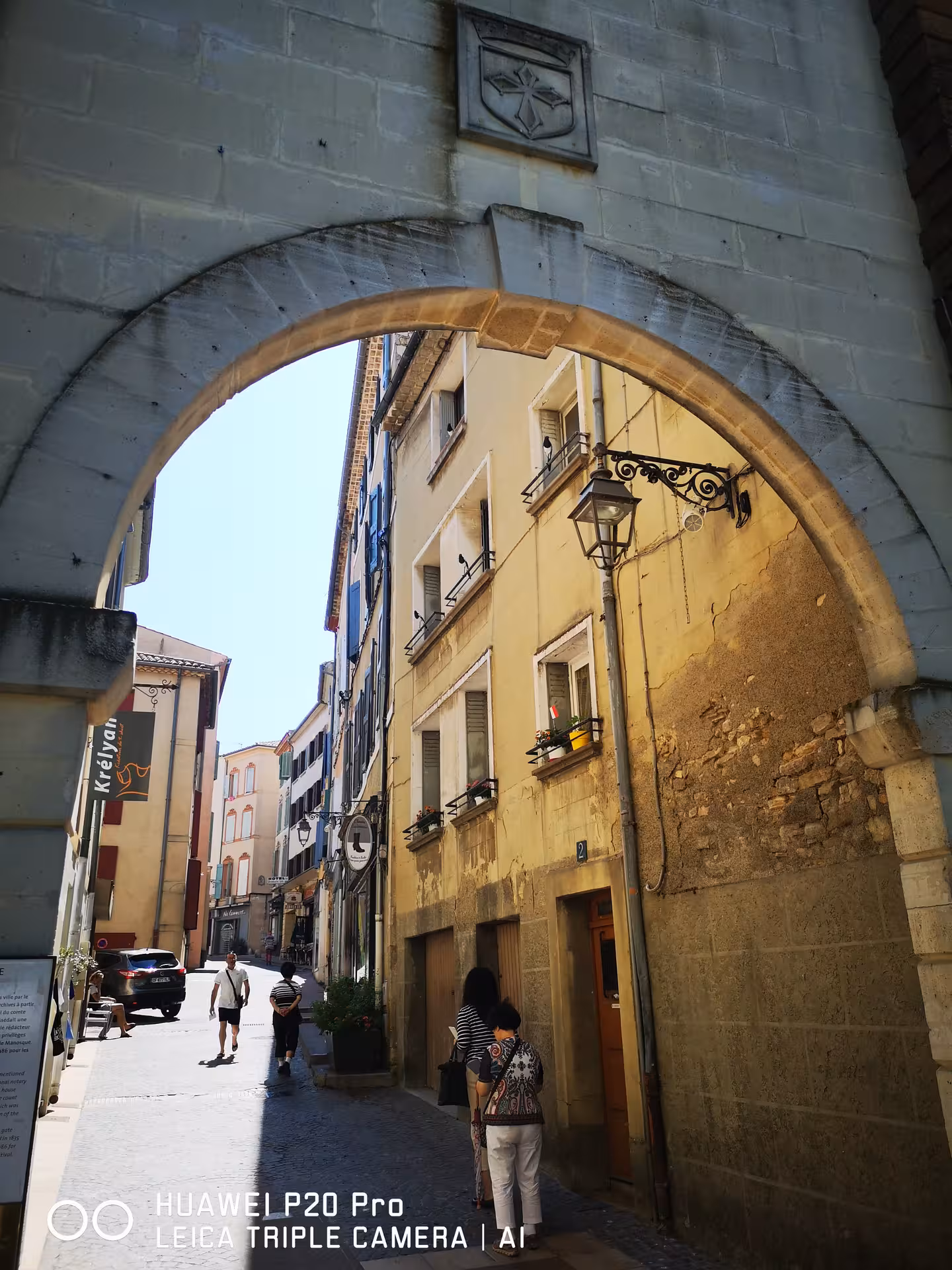 Old stone archway and narrow street in Manosque on private Marseille shore excursion day trip in Provence