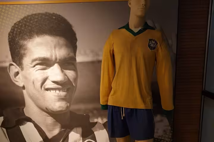 Maracanã tour display of vintage Brazil national team kit beside historic football photo in stadium museum