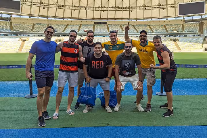 Group photo on the pitch during a Maracanã Stadium tour in Rio de Janeiro with a local guide