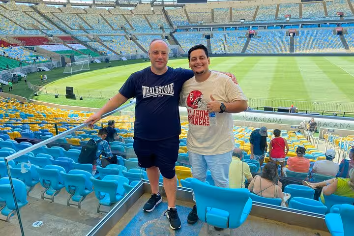 Visitors posing in Maracanã Stadium stands during a Rio de Janeiro guided Maracanã tour with local