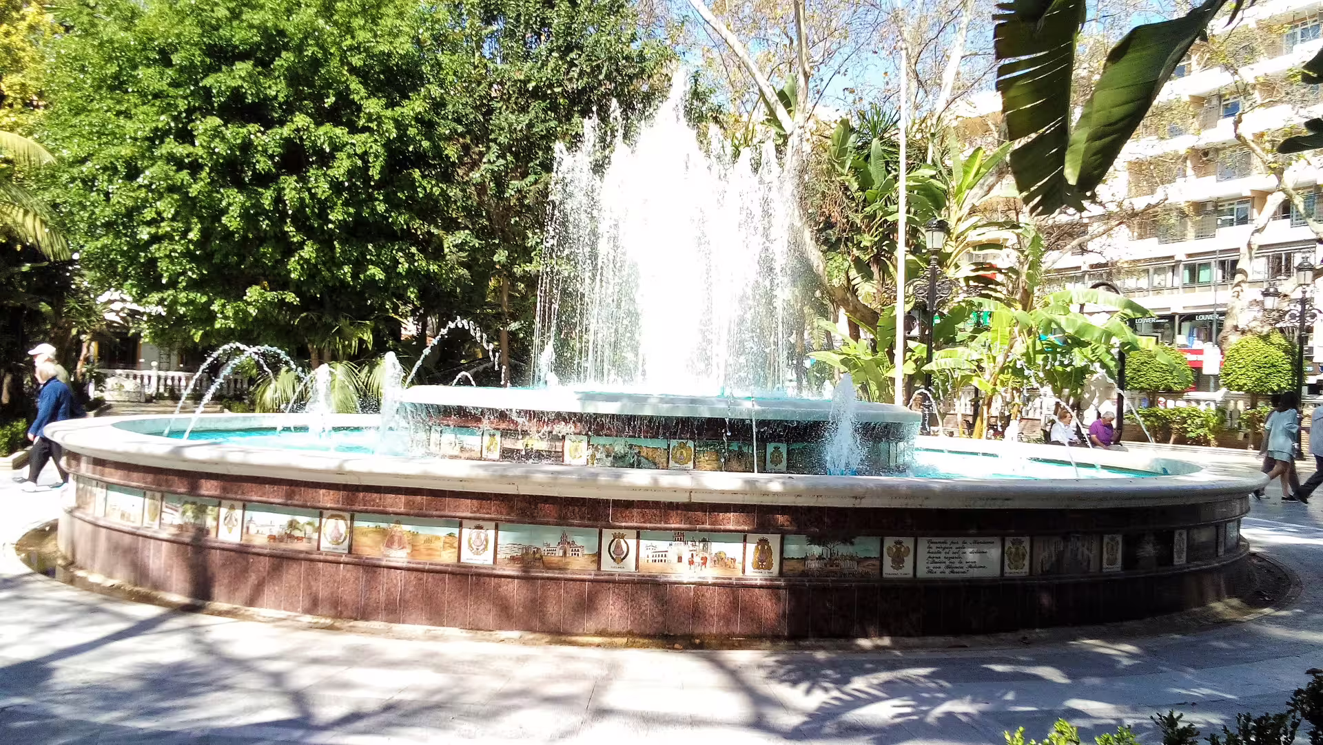 Sunlit fountain in Marbella park, a stop on the Mijas, Marbella and Puerto Banus group trip from Costa del Sol