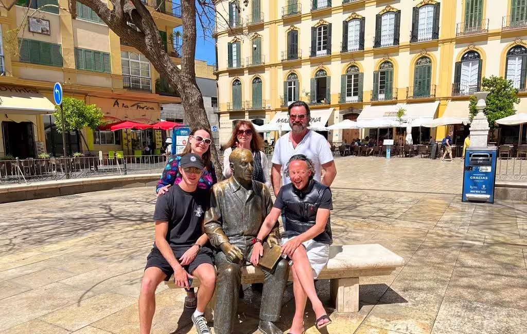 Travelers posing by Picasso statue in Plaza de la Merced on a Marbella to Malaga private guided tour