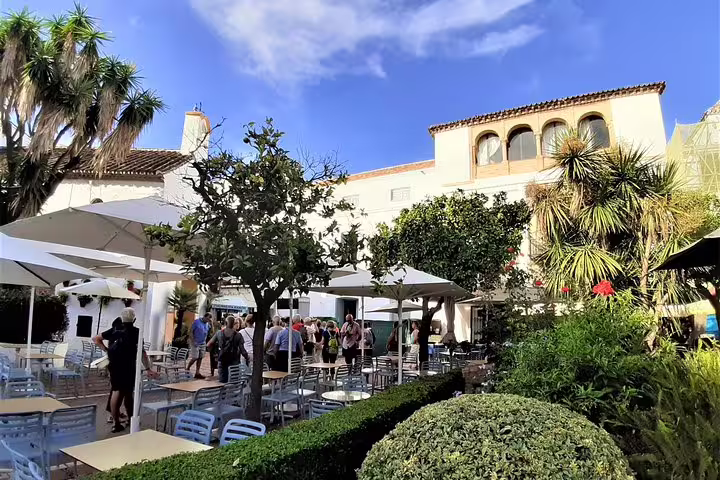 Outdoor café square in Marbella Old Town with gardens, featured on Marbella & Mijas private full-day tour with hotel pick-up