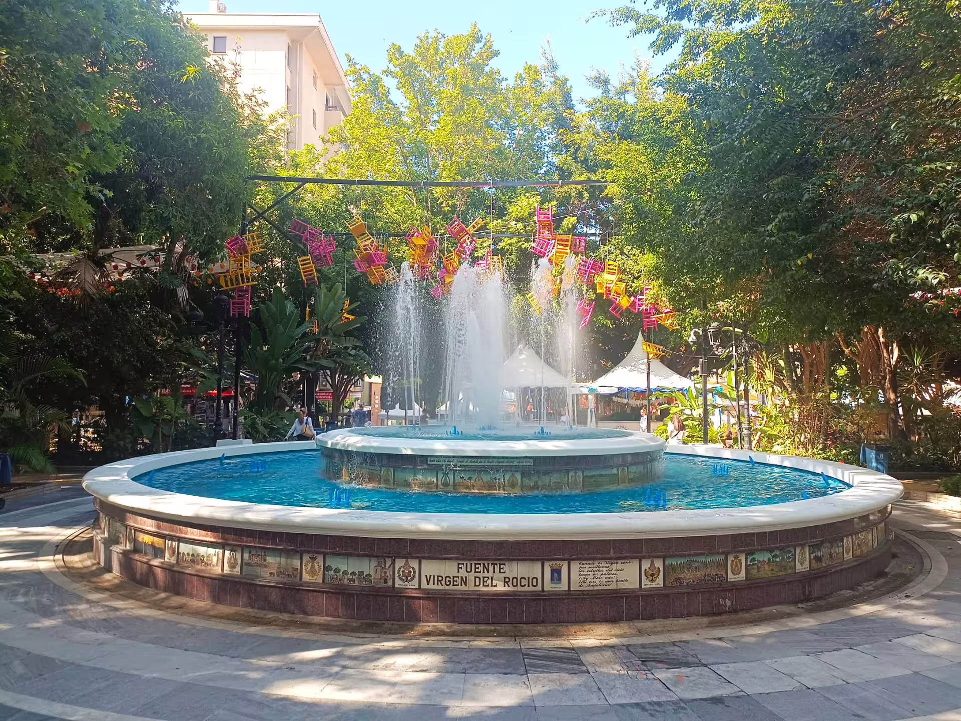 Marbella Old Town park fountain with colorful hanging chairs, cultural stop on private Marbella & Puerto Banus tour