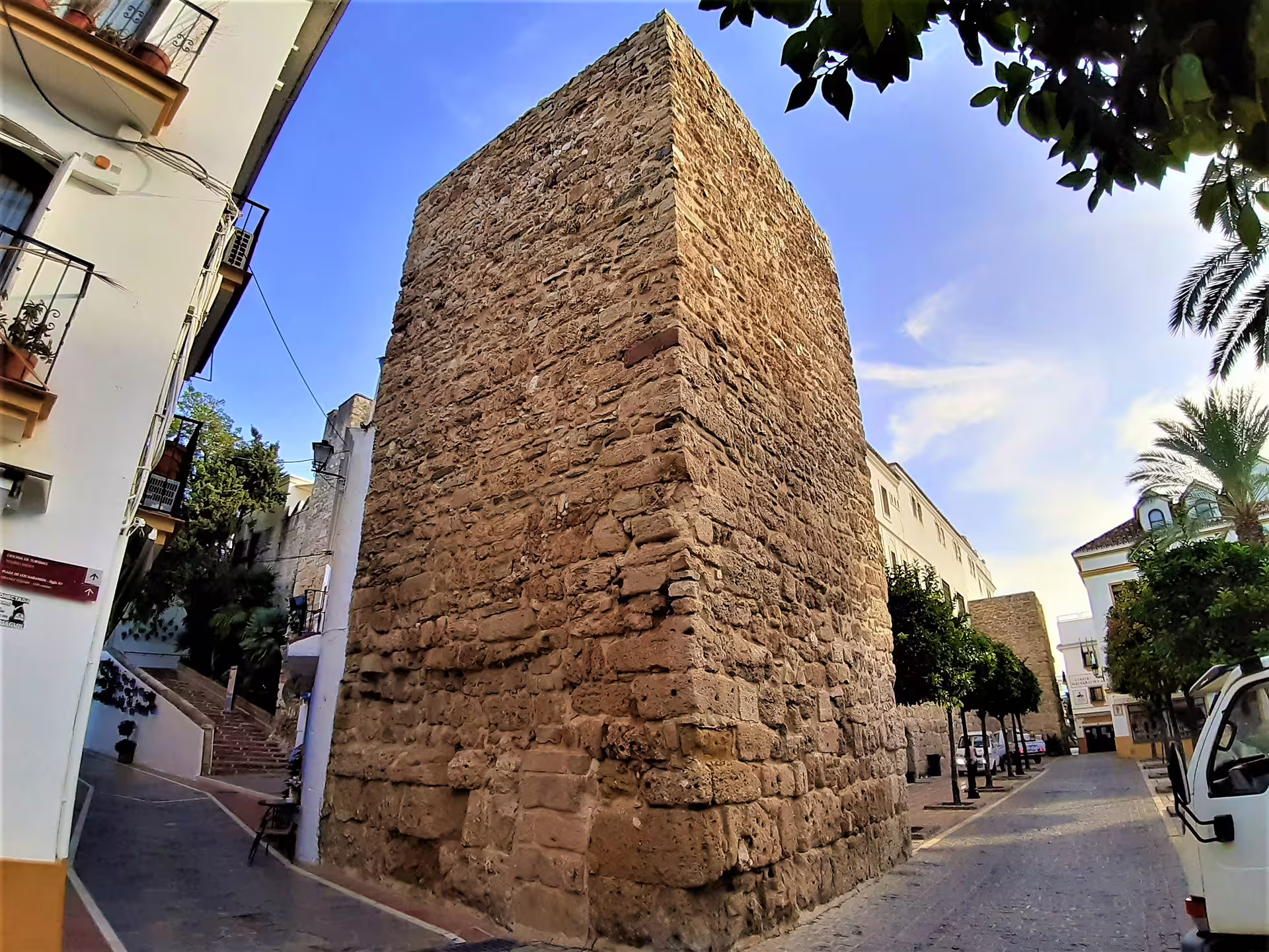 Ancient stone tower in Marbella Old Town streets, a highlight of the Marbella & Mijas private full-day trip with pickup