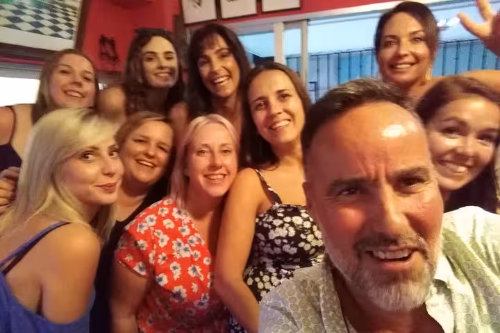 Group enjoying lively tapas night on the Original Marbella Tapas Adventure, capturing smiles and camaraderie.