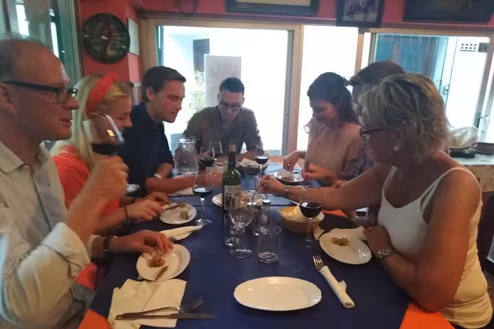 Guests savoring wine and tapas at a cozy table during the Original Marbella Tapas Adventure tour.