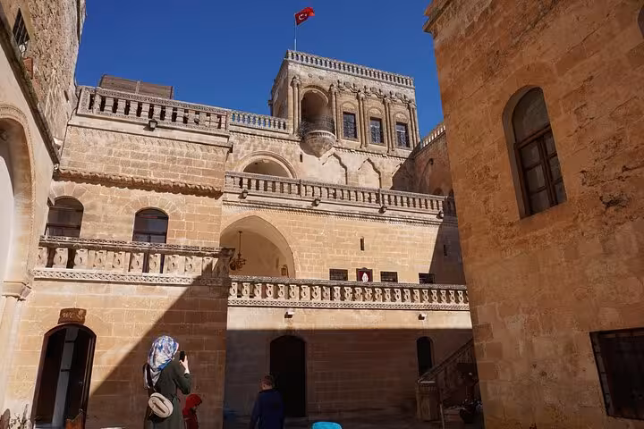Historic Mardin courtyard palace with Turkish flag, photographed on all-inclusive private guided city tour