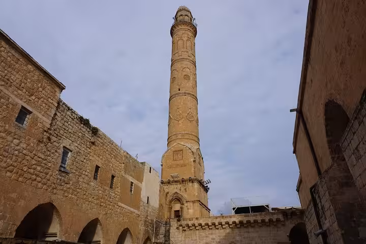 Tall minaret rising above Mardin stone buildings, a highlight on an all-inclusive private guided city tour