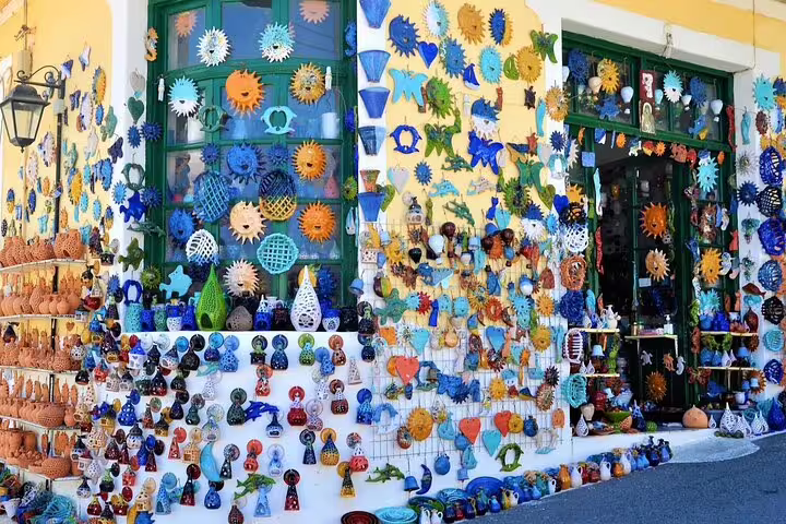 Colorful pottery and artworks displayed in Margarites village, highlighting local craftsmanship and vibrant culture.