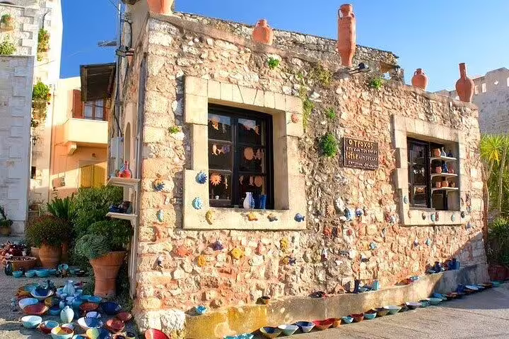 Charming stone pottery shop adorned with colorful ceramics in Margarites village, showcasing local artisan craftsmanship.