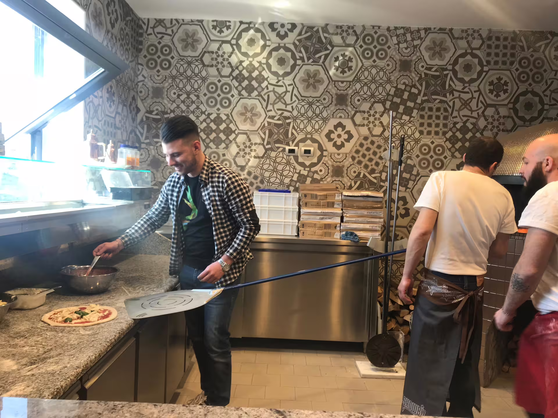 Hands shaping Margherita pizza in Naples cooking class, learning Neapolitan dough technique and wood-fired baking
