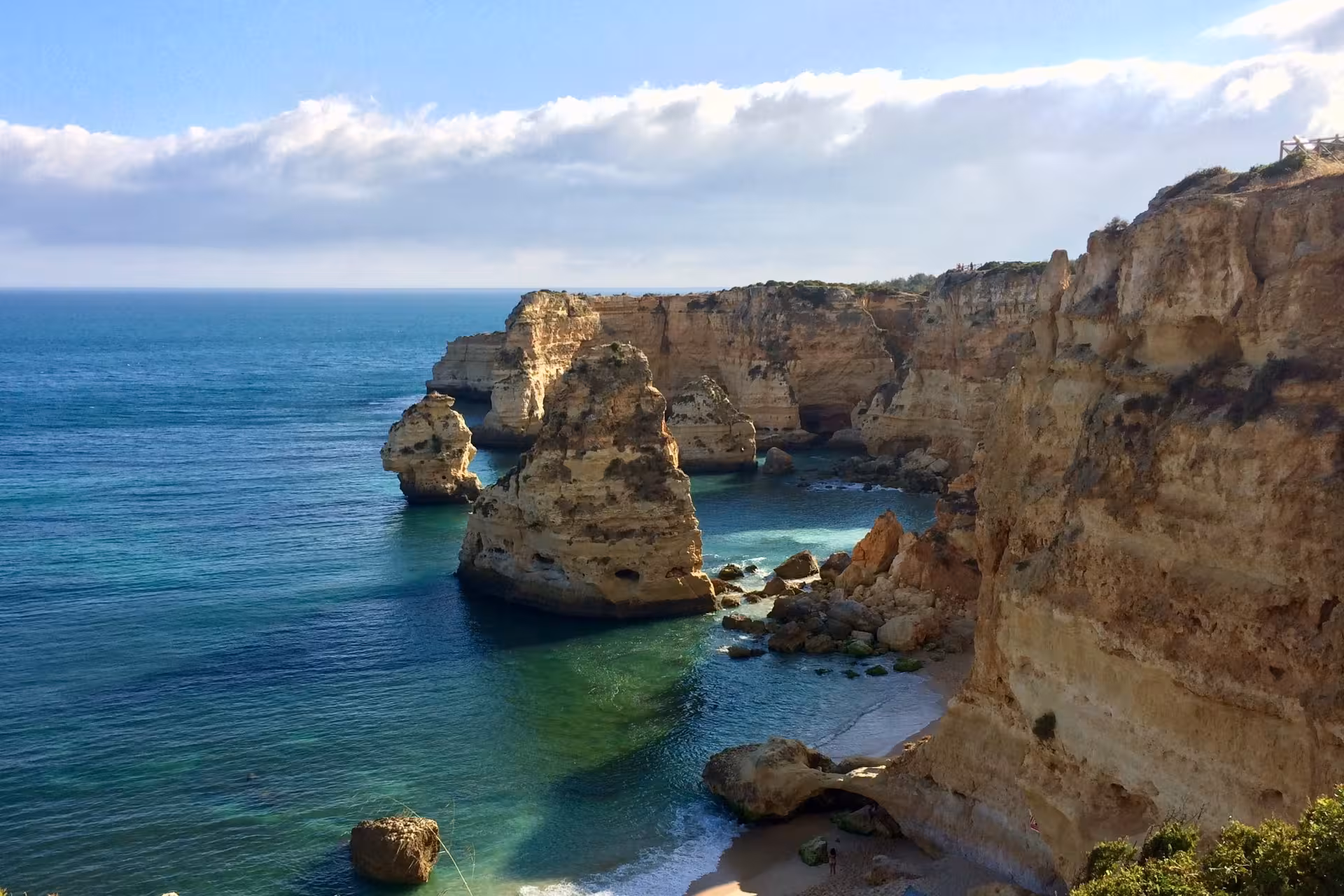 Clifftop view of Marinha Beach’s dramatic limestone stacks and clear Atlantic water on Algarve catamaran tour