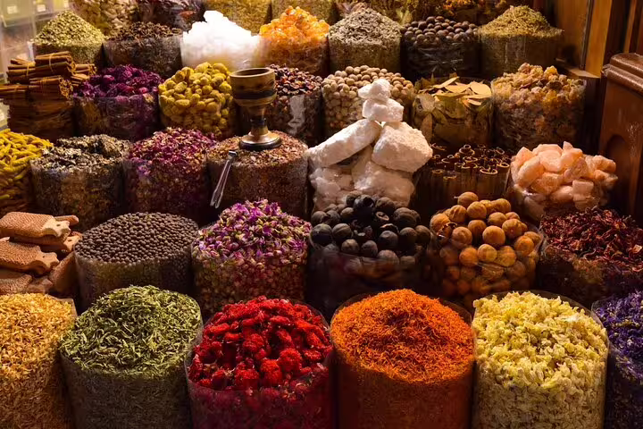 Colorful spice piles in Marrakech souk market on a full-day sightseeing tour with a local guide