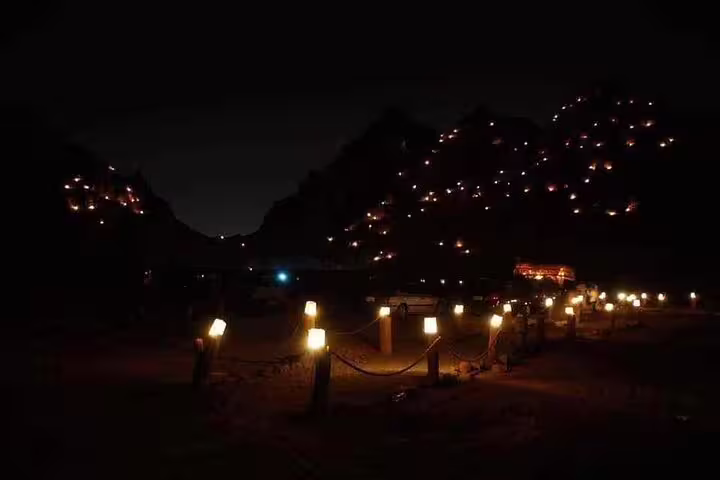Lantern-lit desert camp at night on Marsa Alam Jeep safari adventure tour with dinner and Bedouin show