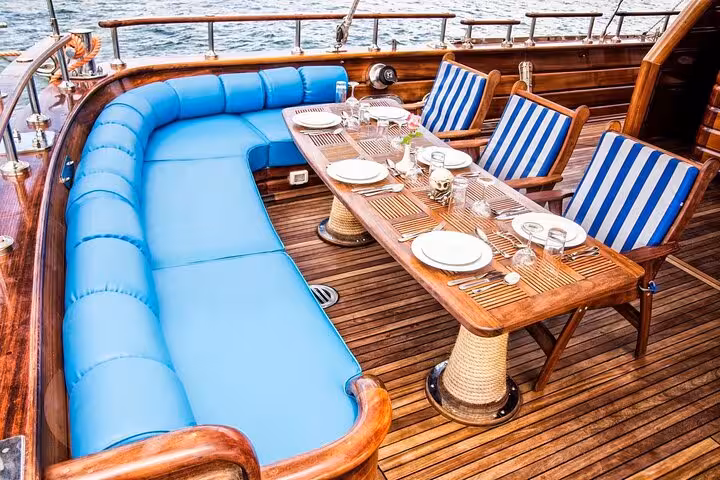 Outdoor dining deck on Marsa Alam pirates sailing boat cruise, set lunch table with sea views on the Red Sea