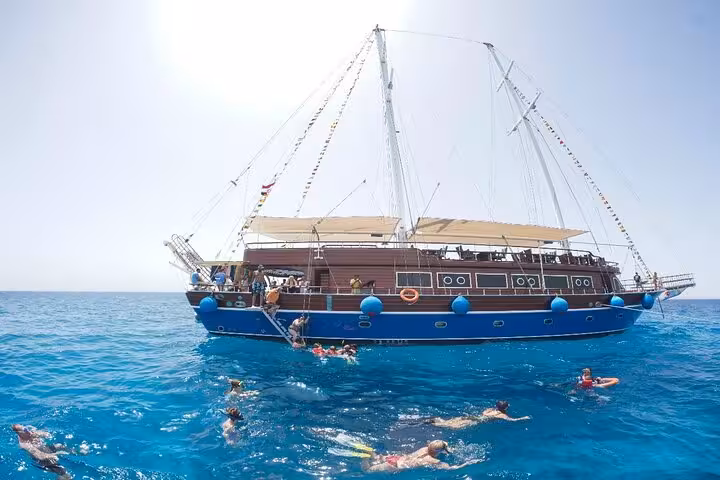 Pirates sailing boat cruise in Marsa Alam with guests snorkeling in Turtle Bay, Red Sea, with pickup included