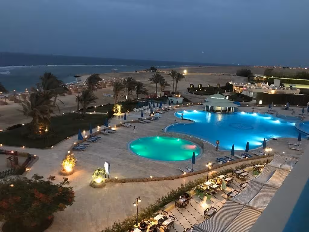 Luxurious resort pool area overlooking the Red Sea at dusk in Marsa Alam, Egypt, perfect for a serene getaway.