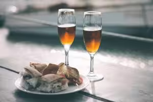 Marsala wine glasses with Sicilian seafood plate, part of Palermo tour tasting olive oil, salt and local wine