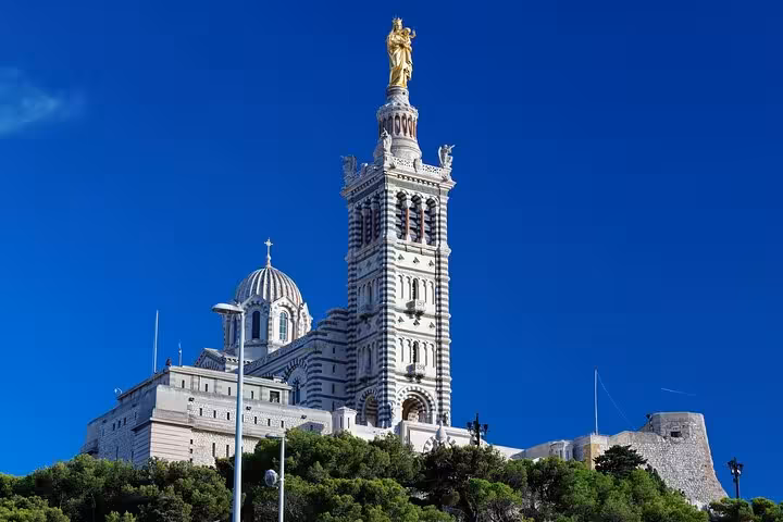 Visit the stunning basilica atop Marseille's hills, offering panoramic views on a private guided city tour.