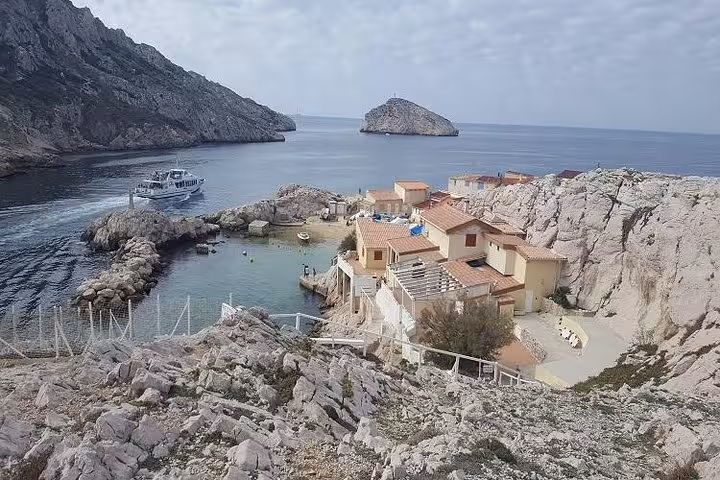 Scenic Calanques cove near Marseille with rocky cliffs, small harbor and boat on a private shore excursion