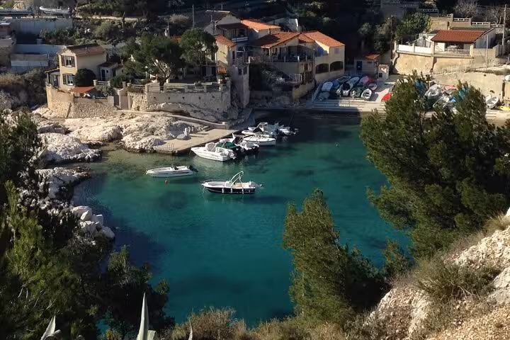 Turquoise cove with small boats near Marseille, scenic stop on a full-day private catamaran tour