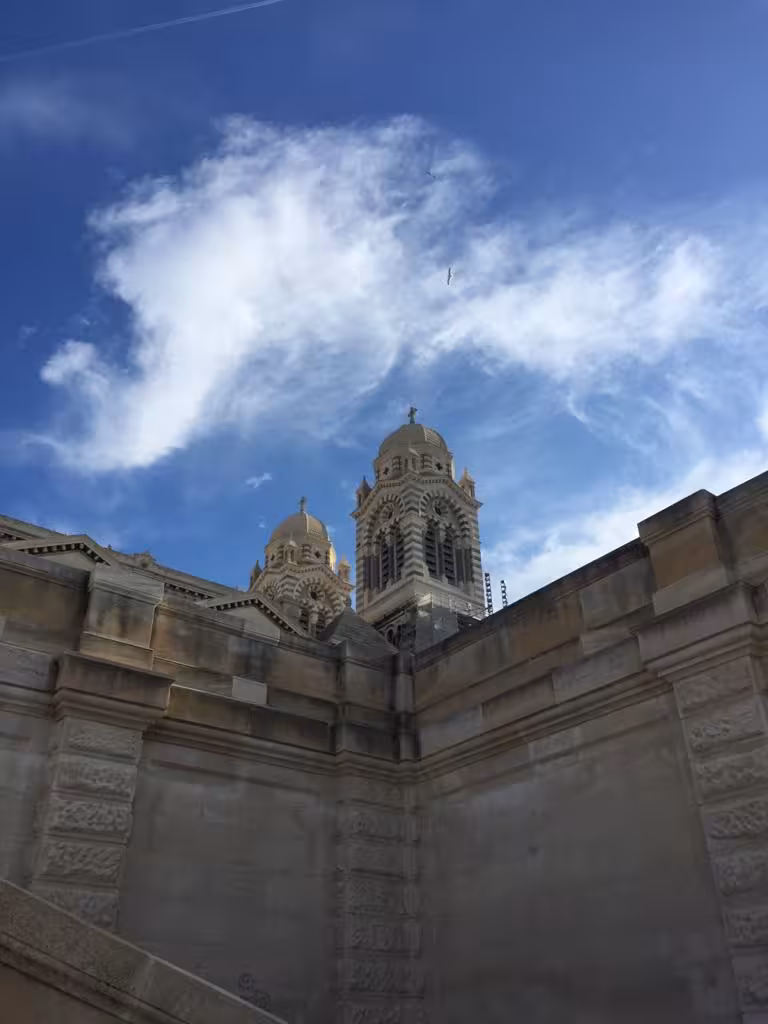 View of Marseille Cathedral La Major domes above stone walls, landmark stop on Le Panier oldest district walking tour