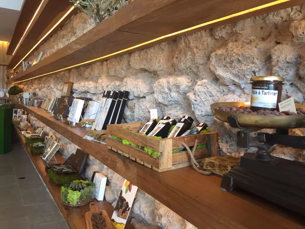 Gourmet chocolate shop stop on a Marseille food tour, artisan treats displayed on rustic wooden shelves