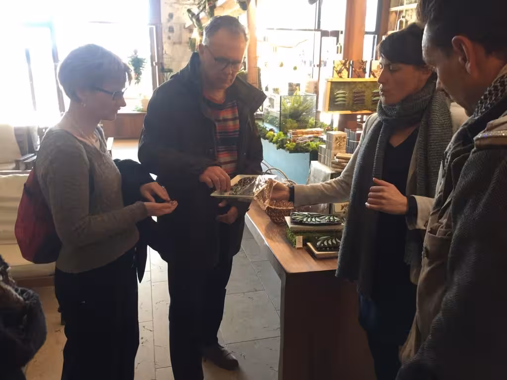 Guests tasting local specialties at a Marseille gourmet shop during guided food tour with Provençal snacks