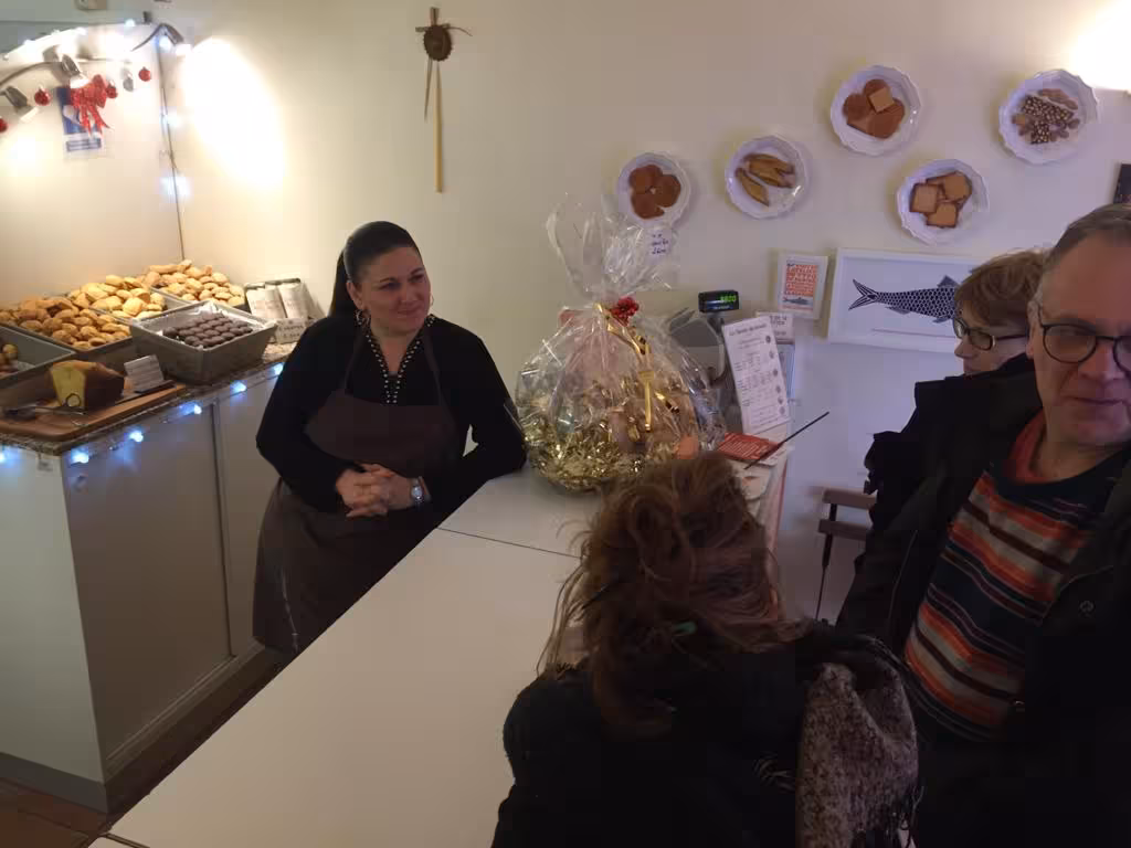 Guide shares local sweets in a Marseille pâtisserie, authentic French tasting stop on a food tour