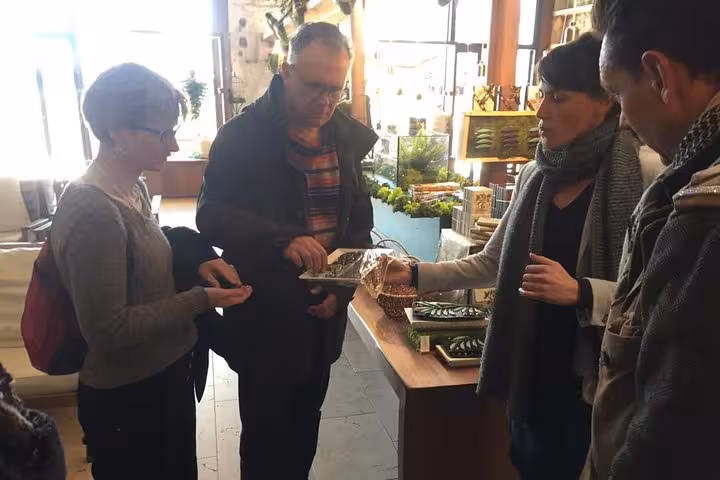 Local guide leads a Marseille market tasting, sampling Provençal specialties on a 3-day local tour