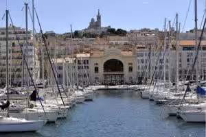 Old Port of Marseille with sailboats and waterfront buildings, a scenic stop on a Marseille food tour