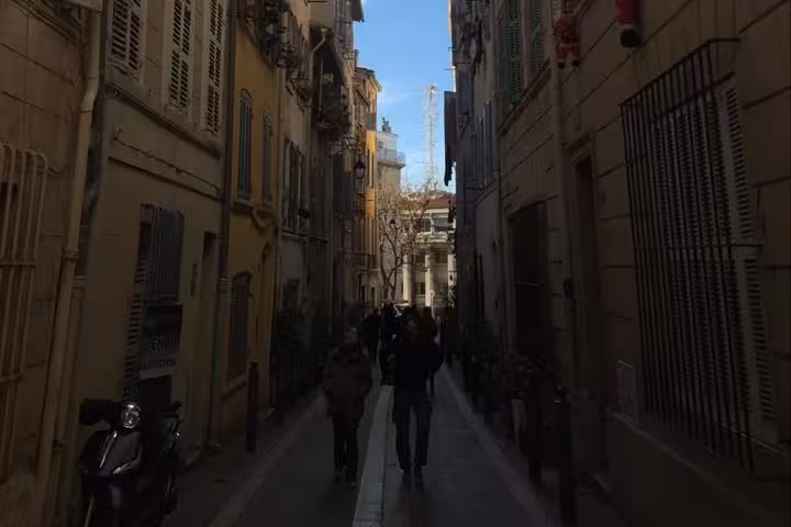 Narrow Marseille old town alley walk on a local 3-day tour, historic buildings and hidden streetscape