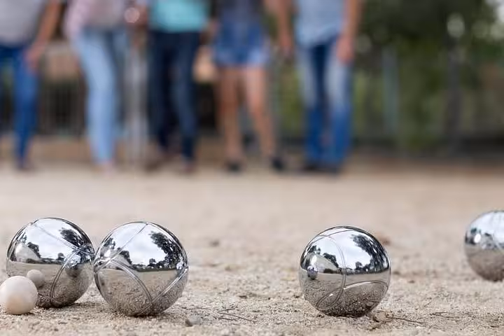Shiny pétanque boules on sandy court in Marseille, classic Provençal game on a 3-day local tour