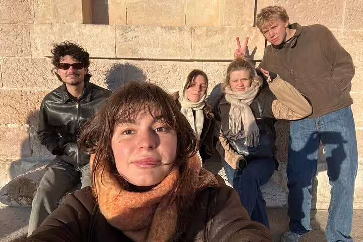 Group selfie on stone steps in Marseille during a self-guided scavenger hunt and sightseeing walking tour