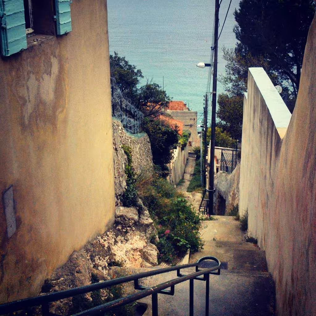 Steep Marseille stairway descending toward the sea, a hidden lane on the urban hiking route to the coast
