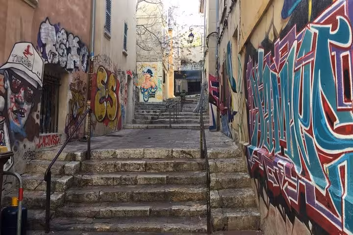 Graffiti-covered stairway in Marseille street art district, exploring hidden spots on a 3-day local tour