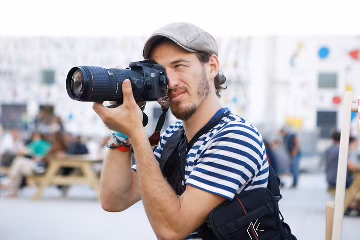 Participant photographing Marseille street scenes with DSLR, guided travel photography workshop and photo walk