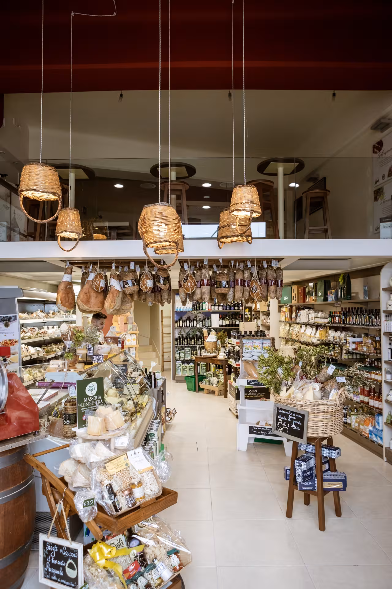 Martina Franca deli shop with hanging capocollo, local wines and Puglia specialties for tasting tour