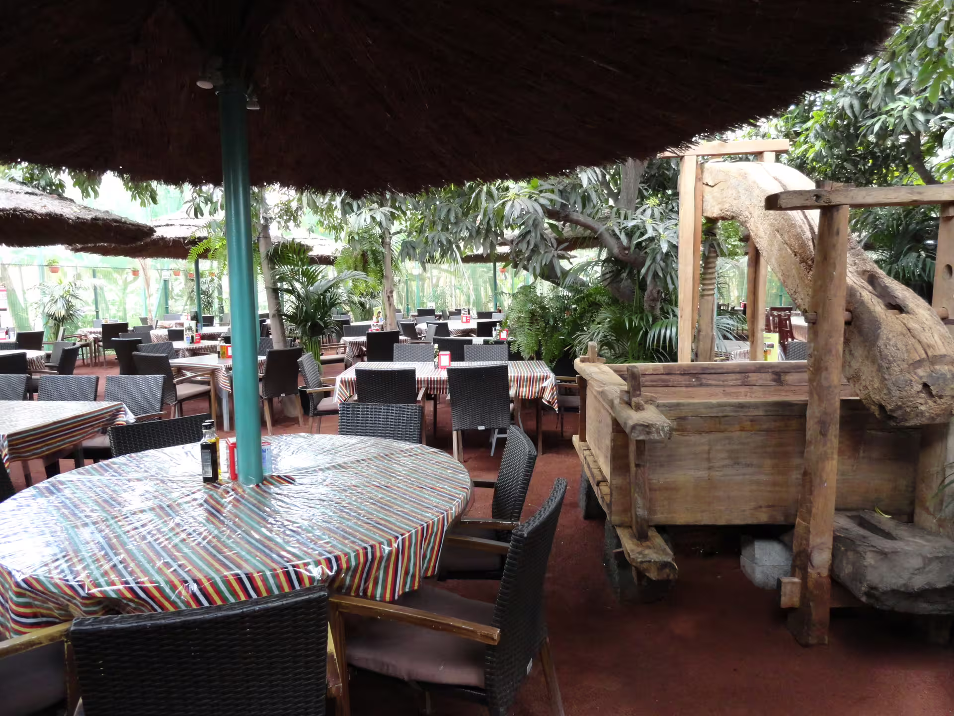 Rustic outdoor dining area with wicker chairs and wooden decor at Masca Gastro Tour.