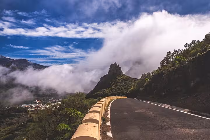 Scenic road with misty mountains in Masca, Tenerife, ideal for cultural and culinary tours.