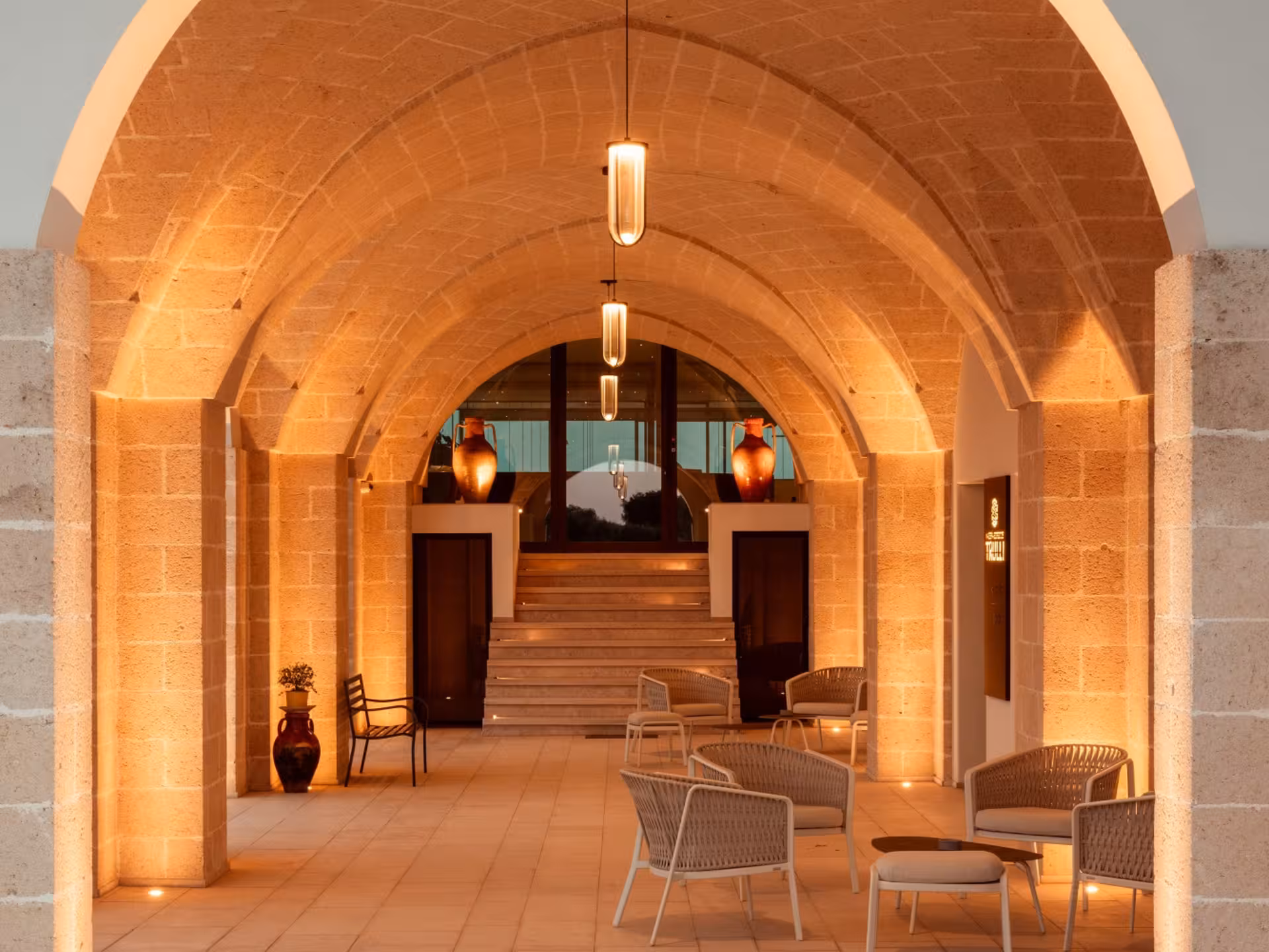 Elegant arched entrance at a Masseria winery near Taranto, perfect for vineyard walks and wine tasting tours.