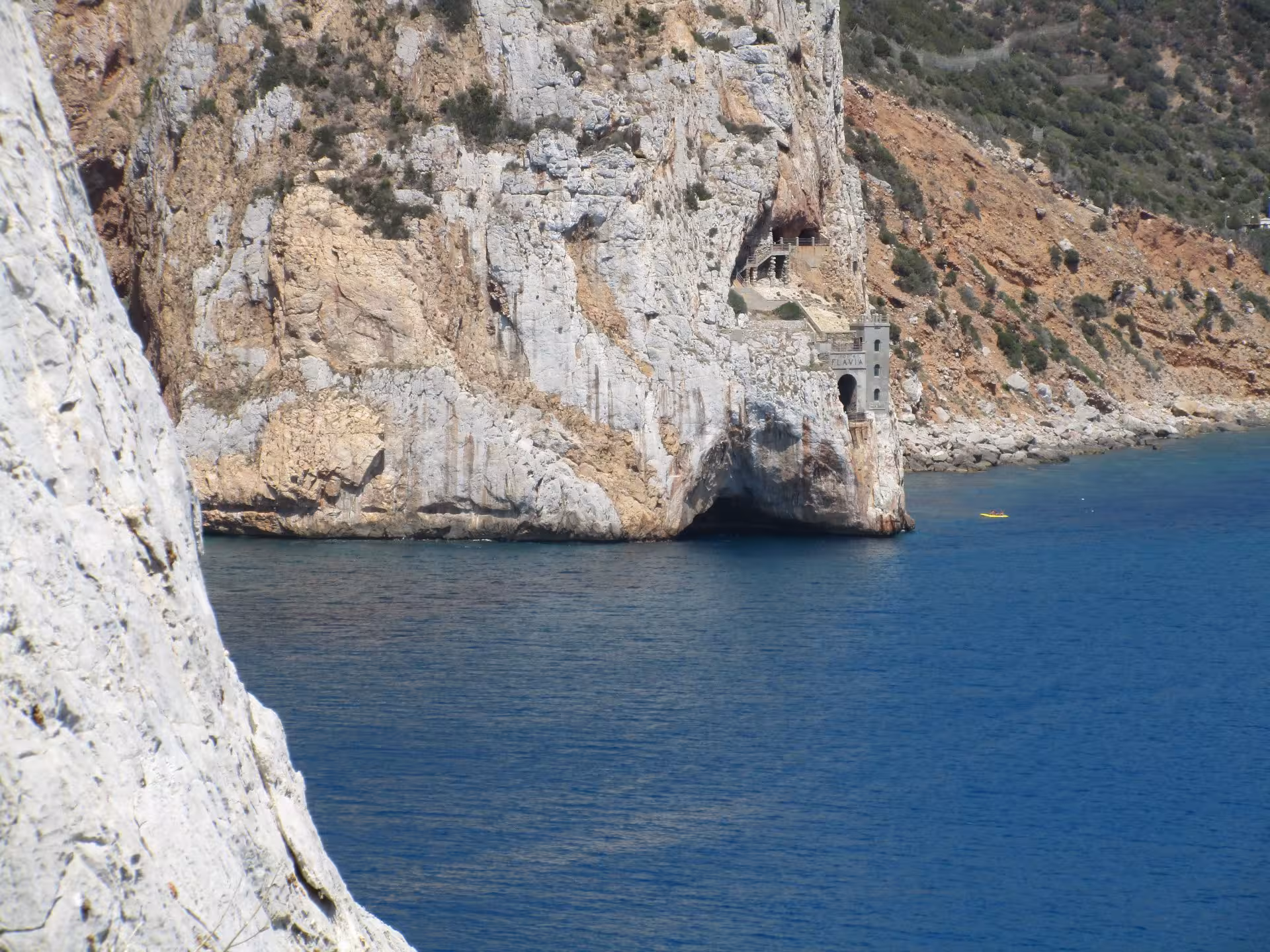 Coastal cliff with Flavia mining entrance near Masua on the Pan di Zucchero climbing route.