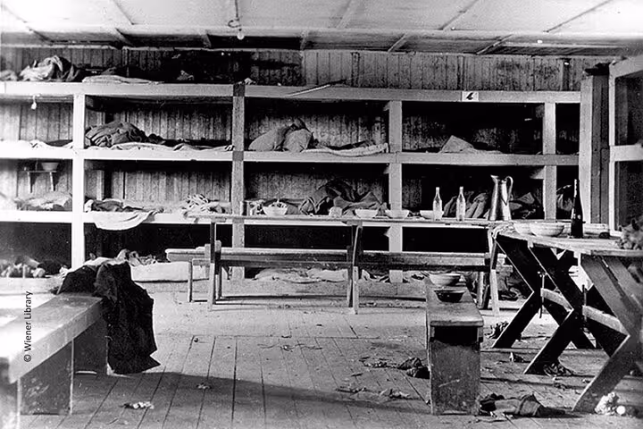 Interior of Mauthausen camp barracks with bunks and belongings, included on Vienna to Mauthausen private tour
