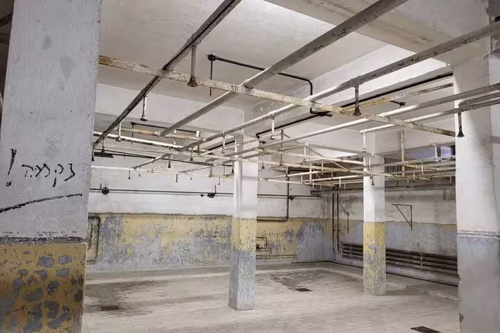 Interior of Mauthausen Memorial barracks basement with pipes and columns, visited on a private day trip from Vienna